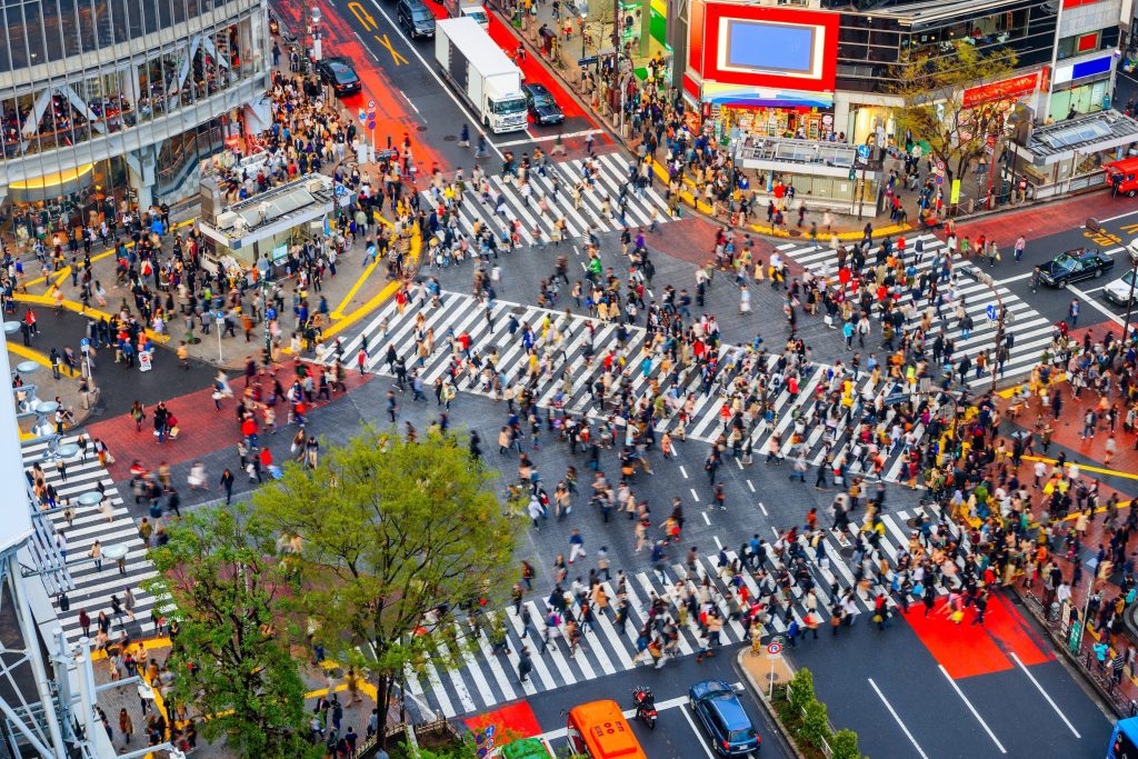 Shibuya, Tokyo, Japan crosswalk and cityscape in the late afternoon.