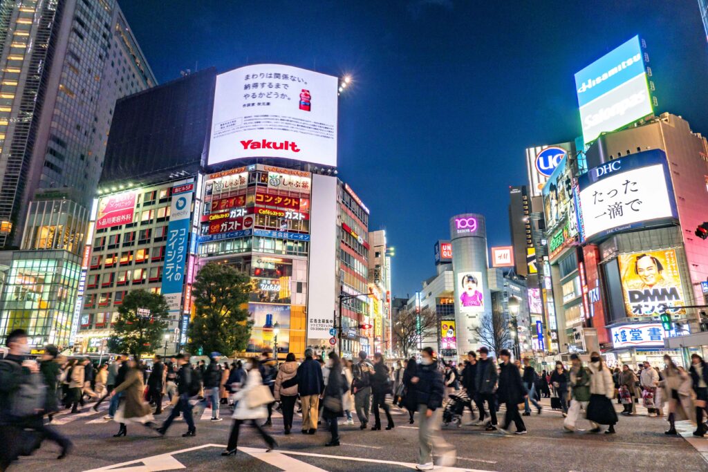 Crowds of people at a busy crossing in Shinjuku at twilight