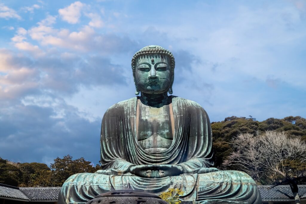 A towering Buddha statue is captured under clear skies at a popular landmark in Japan